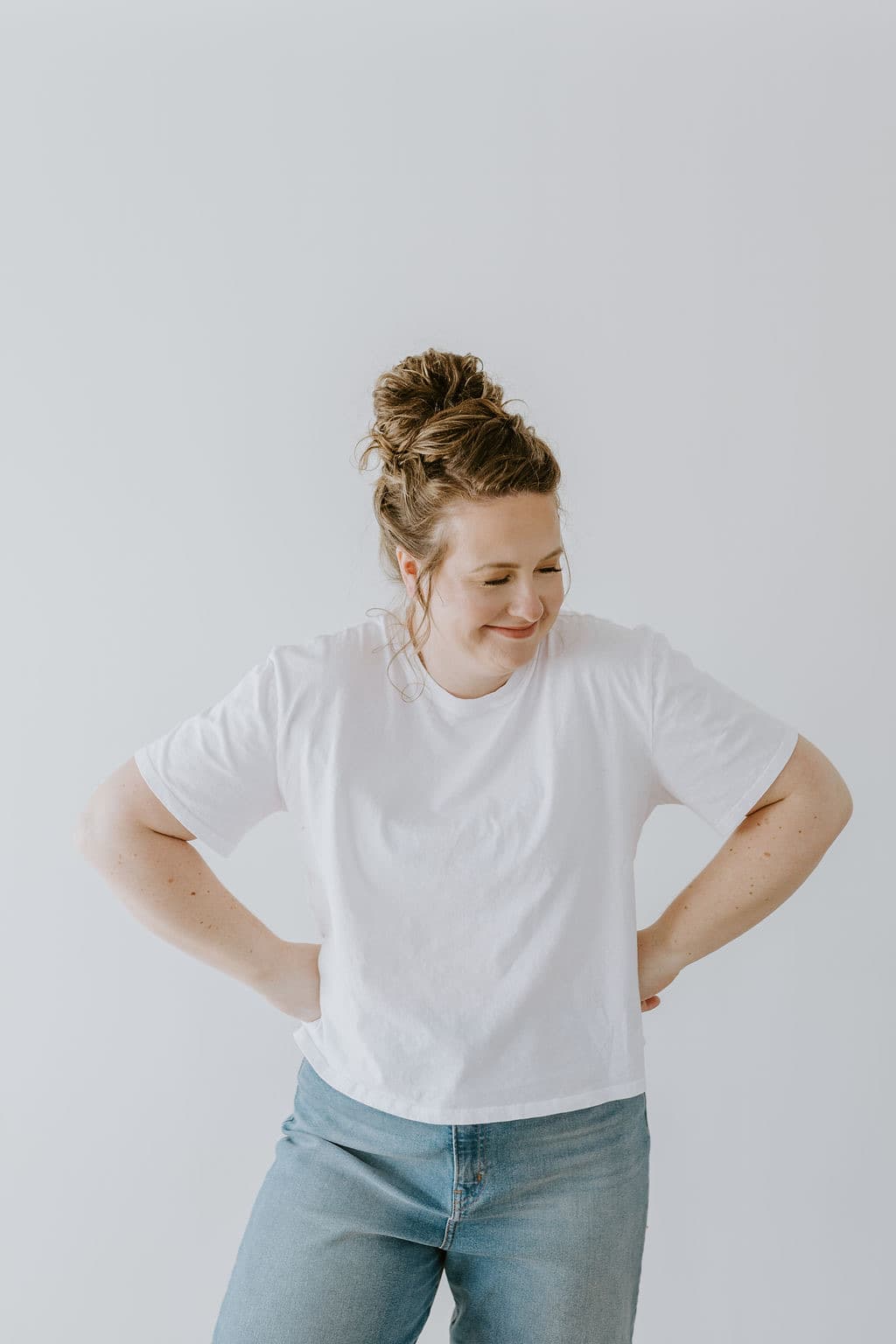 Megan Nakazawa in a white tee and jeans, hands on her hips